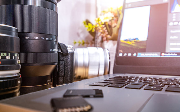 Photographer Concept Work Space Photographer With DSLR Camera Lense And Computer Laptop