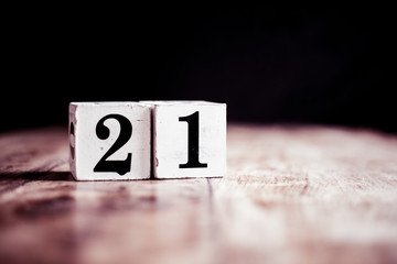 Number 21 isolated on dark background- 3D number twenty one isolated on vintage wooden table