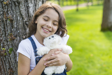 Girl hugging a stuffed toy