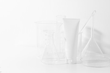 skincare cosmetic mockup lotion bottle pakage on white background, sunscreen protection with laboratory science glass tube