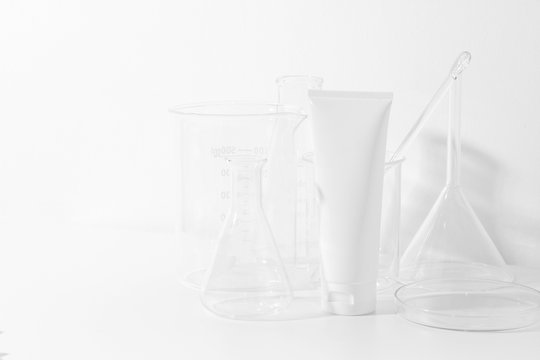 skincare cosmetic mockup lotion bottle pakage on white background, sunscreen protection with laboratory science glass tube