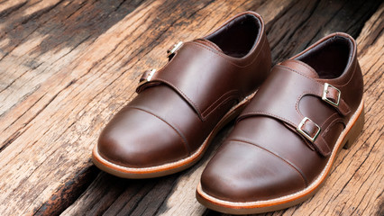 Men fashion of loafer brown shoes on wooden background.