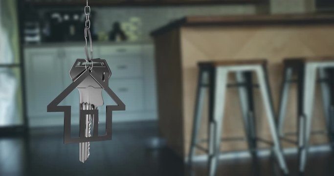 House keys and key fob hanging over out of focus kitchen 4k