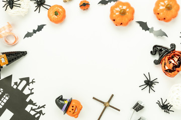 Table top view aerial image of decoration Happy Halloween day background concept.Flat lay accessories essential object to party the pumpkin & doll and hat on white wooden.Space for creative design.