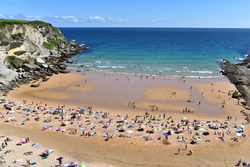 Fototapeta na wymiar People on the Playa de Los Molinucos Beach in Santander, Cantabria, North Spain