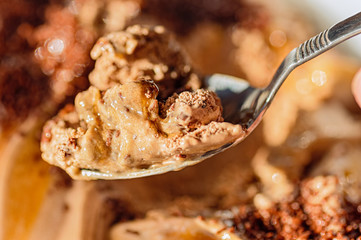 Chocolate ice cream on a spoon close-up. Austrian dessert.
