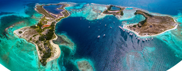 Caribbean: Vacation in the blue sea and deserted islands. Aerial view of a blue sea with crystal water. Great landscape. Beach scene. Aerial View Island Landscape Los Roques - obrazy, fototapety, plakaty