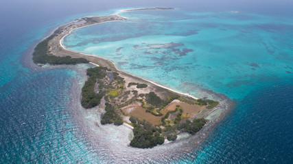Fototapeta na wymiar Caribbean: Vacation in the blue sea and deserted islands. Aerial view of a blue sea with crystal water. Great landscape. Beach scene. Aerial View Island Landscape Los Roques