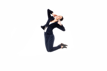attractive businesswoman jumping in dance while listening music in headphones isolated on white