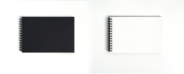 Notebook mock up with clean black blank for design and advertising. Notepad with chromed spring and free copy space template. On the gray background.