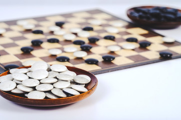 Obraz na płótnie Canvas Board game Go and black and white bones. Go or wei-Chi ,asian board game.