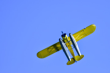 Vintage seaplane flying over the lake
