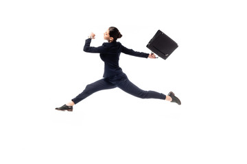 side view of young businesswoman with briefcase jumping in dance isolated on white