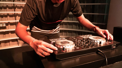 portrait of a male with hat Disc jockey or dj playing turn table, mixer, music