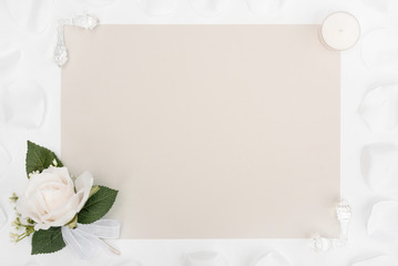 Flat lay wedding card with white flower decoration