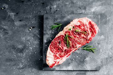 Prime raw strip beef steak New York with a high marbling conten close up