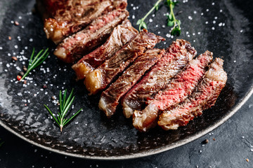 New York Strip steak medium rare with rosemary top view 