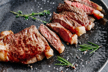 New York sirloin beef steak medium rare with rosemary top view 