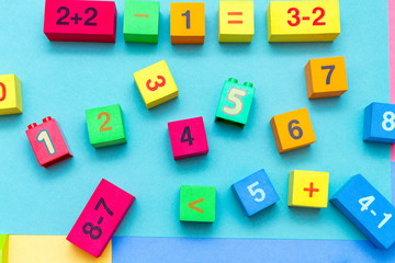 child kid colorful education toys cubes with numbers math pattern background on the bright background. Flat lay. Childhood infancy children babies concept.