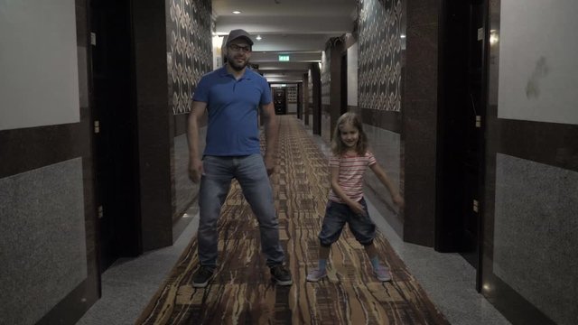 Happy Father With Little Daughter Dancing And Have Fun In A Hotel On Vacation. Little Daughter And Father Enjoying Dance , Having Fun Together, Party. Floss Dance Viral. Slow Motion.