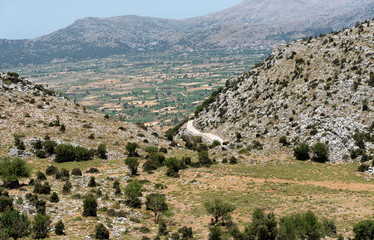 Fototapeta na wymiar Crete, Greece, June 2019. A view of the Lasithi Plateau from above in the Lasithi Mountains of central Crete.