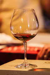 Red wine glass in a wine cellar.