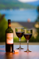 Two glasses and a bottle of red wine.