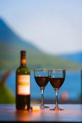 Red wine and glasses with a view still life.
