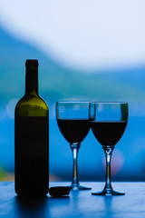 Red wine and glasses with a view still life.