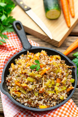 Boiled and fried buckwheat with carrots and zucchini