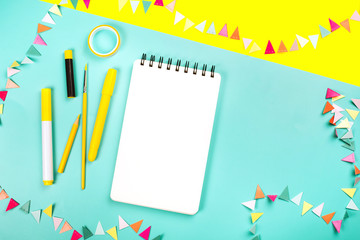 School supplies on yellow and pink background with copy space. Back to school concept.