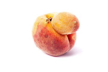 Trendy ugly food. Peach fruit isolated on white background. Misshapen produce, food waste problem concept.