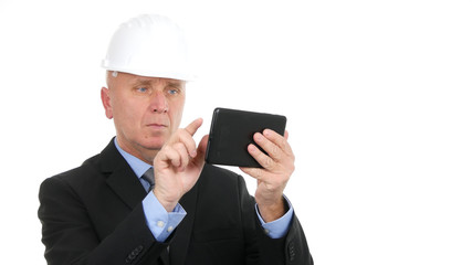 Image with Businessman Wearing Hardhat and Using Electronic Tablet