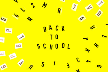 Back to school concept. Letters on yellow background.
