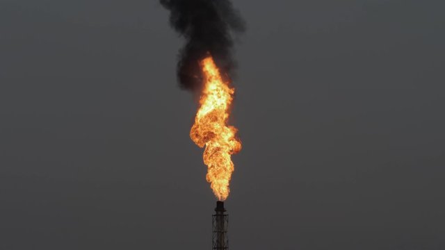 Gas flare and smoke of petrochemical refinery in  twilight