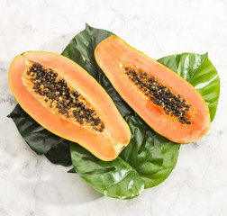 Close-up papaya on monstera leaf