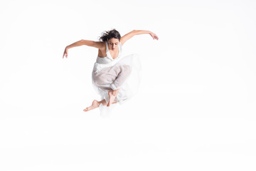 beautiful, graceful ballerina in white dress jumping in dance isolated on white