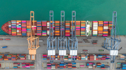 Fototapeta premium Container ship in export and import business logistics and transportation. Cargo and container box shipping to harbor by crane. Water transport International. Aerial view and top view.