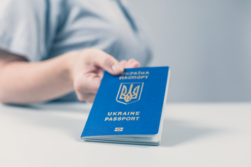 Immigration and passport control at the airport. woman border control officer with Ukrainian passport. Concept