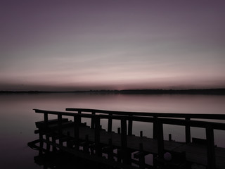 Fototapeta na wymiar Empty wooden bridge at sunset. Soft sunlight