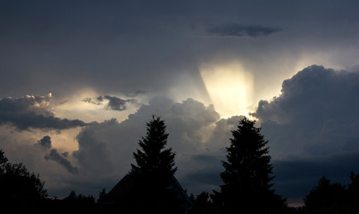 The sun's rays break through the dark clouds.