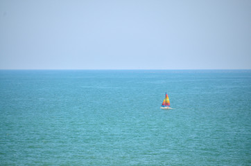 Fototapeta na wymiar Sailboat sails gently on the sea
