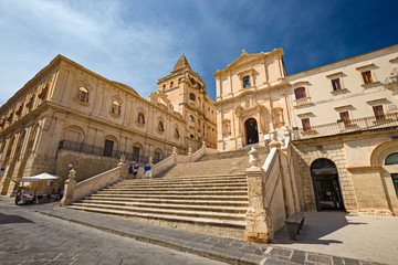 Fototapeta na wymiar Scenic entrance stairway and façade of the baroque church of S. Francesco d'Assisi and Monastery of S. Salvatore in Noto, Sicily Italy.