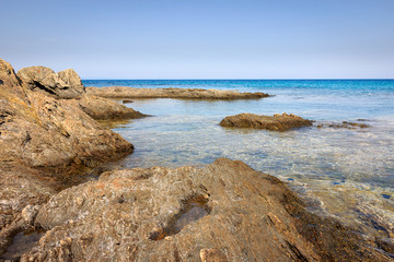 Fototapeta na wymiar Calm translucent turquoise sea, beautiful rocky reef and underwater sea creatures