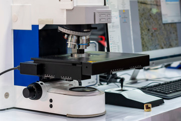 Close up sample or specimen during inspection by modern and accuracy microscope for quality control in industrial metallurgy electronic science etc of laboratory connect with monitor display