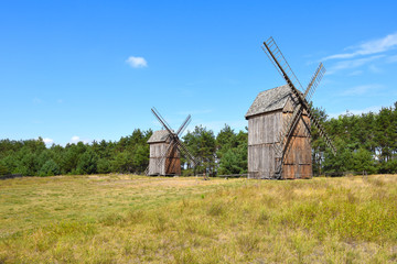 Plakat Old wooden windmills in The Folk Culture Museum in Osiek by the river Notec, the ethnographic park covers an area of 13 ha. Poland, Europe