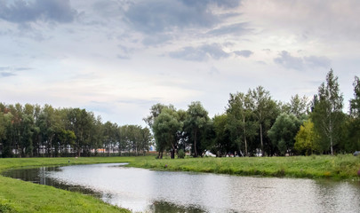 Beautiful sky on the Insar. Forest river landscape. River forest view. Forest river summer scene. Forest river water