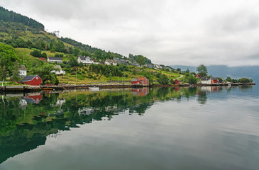 Fototapeta na wymiar Norway, Rosendal rural town fjords seaside in summer, Hordaland county. Rosendal is located on the Hardangerfjord, the second largest fjord in Norway.