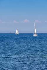 Obraz premium Splendid panoramic view of the crystal blue sea of the island of Elba in Italy with boats on the horizon