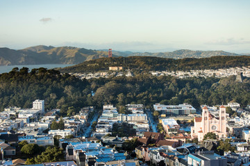 Low aerial view of Inner Sunset and Richmond districts of San Francisco with Golden Gate Bridge in Background - obrazy, fototapety, plakaty